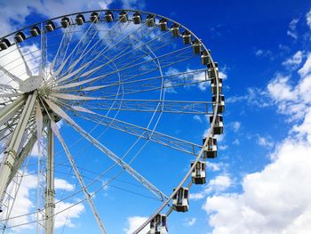 Low angle view of ferris wheel against sky