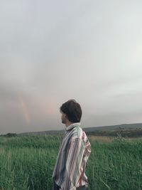 Rear view of woman standing on field