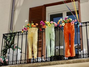 Balcony decoration of a shop with trousers and flowers