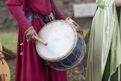 Minstrel playing drum during the annual medieval festival in luzarches, france.