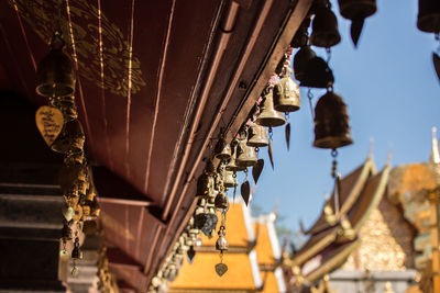 Low angle view of decoration hanging outside building against sky