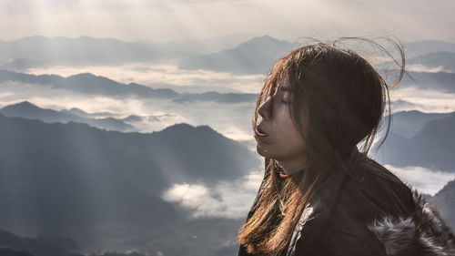 Woman against mountain range against sky