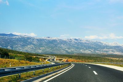 Country road leading towards mountains