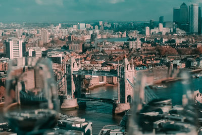 Aerial view of river amidst buildings in city