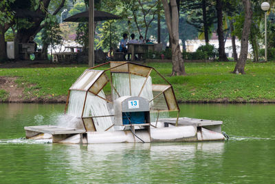 Boat in lake by trees in park