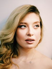 Close-up portrait of woman against white background