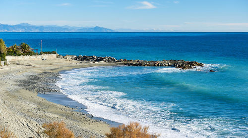 Scenic view of sea against blue sky