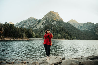 Full length of woman standing on lake against sky