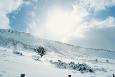 Scenic view of mountains against cloudy sky