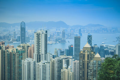 Aerial view of buildings in city against sky