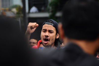 Man screaming while clenching fist at outdoors