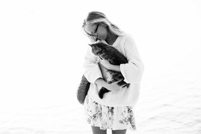 Woman blonde hugging a scottish kitten on a walk