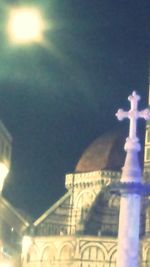 Low angle view of illuminated statue against sky