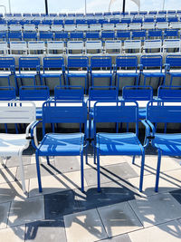 Empty chairs in blue and white in a stadion outdoor