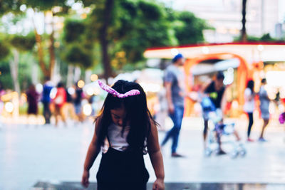 Rear view of people walking in city
