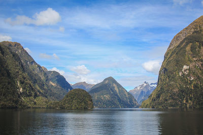 Scenic view of lake and mountains against sky