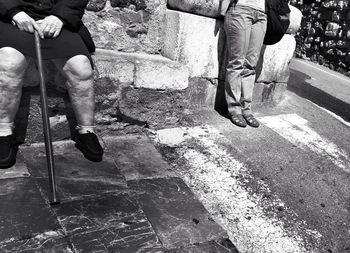 Low section of man and woman wearing shoes