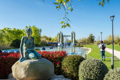 Statue in park against sky