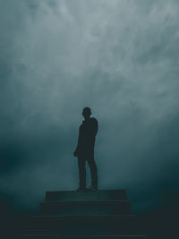 Low angle view of silhouette statue against sky