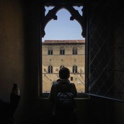 Low angle view of woman standing in front of building