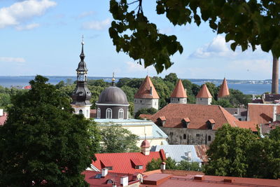 High angle view of bell tower in town against sky