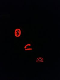 Close-up of stop sign against black background