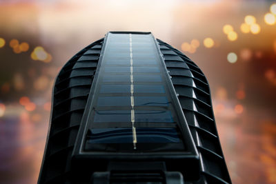 Public city light with solar panel powered on blue sky with clouds