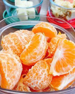 Close-up of orange slices in glass container on table