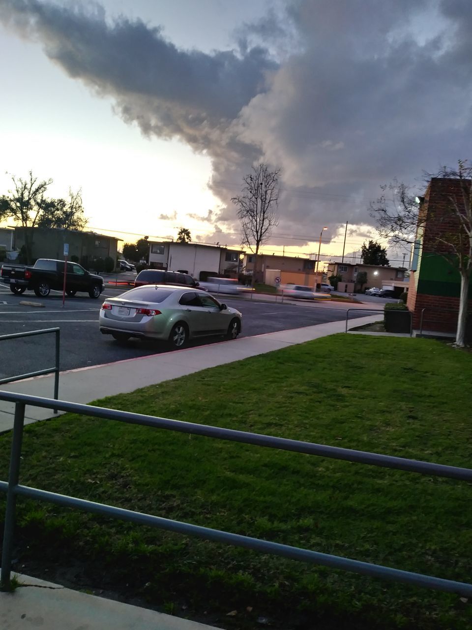 CARS ON ROAD BY BUILDINGS AGAINST SKY