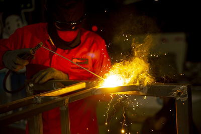 Welder used grinding stone on steel in factory with sparks, welding process at the industrial work