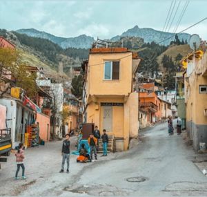 People on street amidst buildings in town