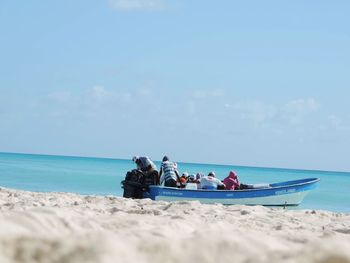 People on beach against sky