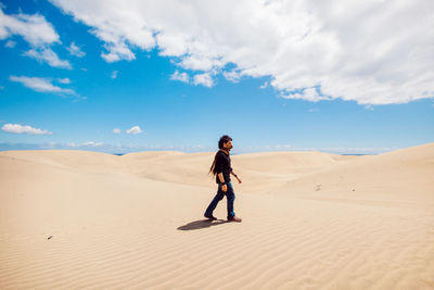 Full length of man standing on desert