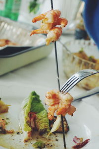 Close-up of roasted prawns in skewers on plate