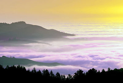 Scenic view of silhouette mountain against dramatic sky during sunset
