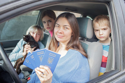 Ukrainian refugees flee from russian invasion, cross board by car together with pet, seek protection