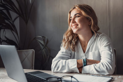 Portrait of young woman working at home