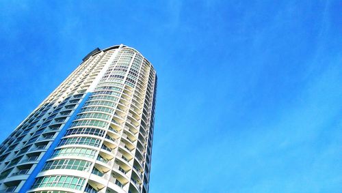 Low angle view of modern buildings against clear blue sky