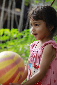 Portrait of young woman with balloons