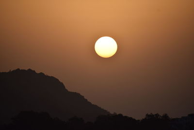 Low angle view of silhouette sun against sky during sunset