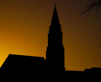 Low angle view of building against sky at sunset