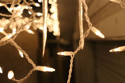 Low angle view of illuminated lamp at night