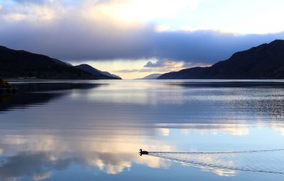 Scenic view of lake against sky during sunset