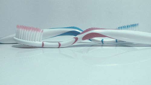 Close-up of toothbrushes on table