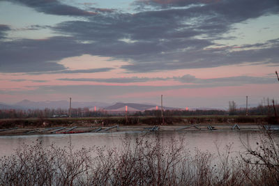Scenic view of river against sky during sunset