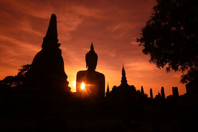 Silhouette temple against sky during sunset