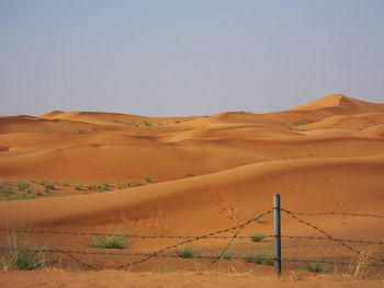 Scenic view of desert against clear sky