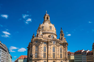 Low angle view of buildings against blue sky