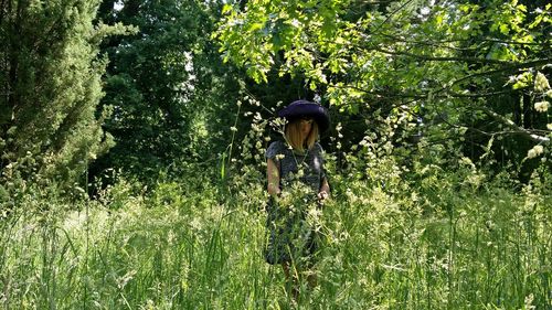 Woman amidst trees in forest
