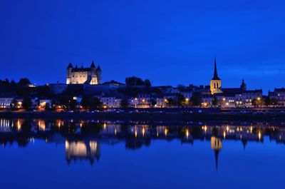 Reflection of illuminated buildings in water at night